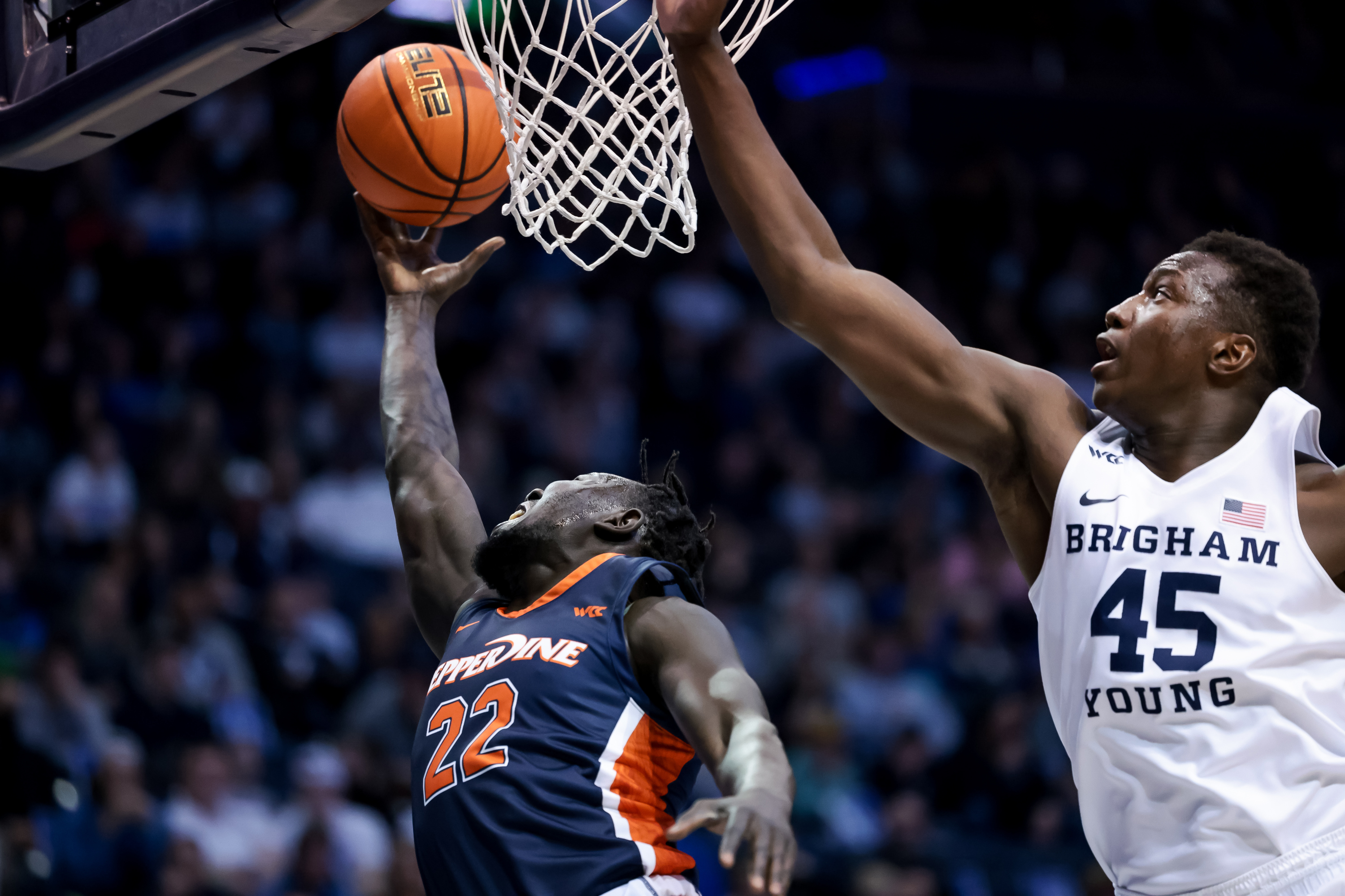 Pepperdine Waves guard Majok Deng (22) goes to the hoop around Brigham Young Cougars forward Fousseyni Traore (45) during the game at the Marriott Center in Provo on Saturday, Feb. 26, 2022.