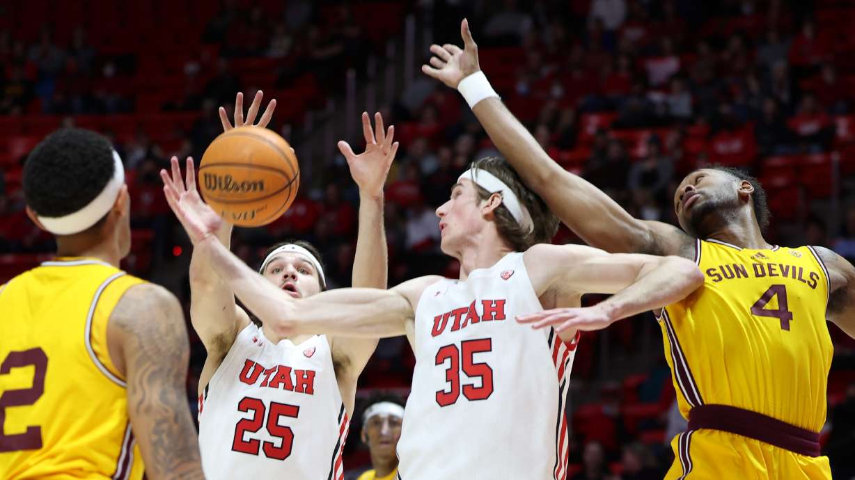 Utah Utes guard Rollie Worster (25) and Utah Utes center Branden Carlson (35) battle Arizona State Sun Devils forward Kimani Lawrence (4) for the rebound as Utah and Arizona State play an NCAA basketball game in the Huntsman Center at the University of Utah in Salt Lake City on Saturday, Feb. 26, 2022.