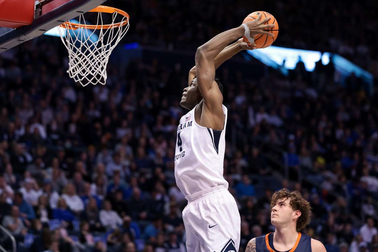 Brigham Young Cougars forward Atiki Ally Atiki (4) dunks during the game against the Pepperdine Waves at the Marriott Center in Provo on Saturday, Feb. 26, 2022.