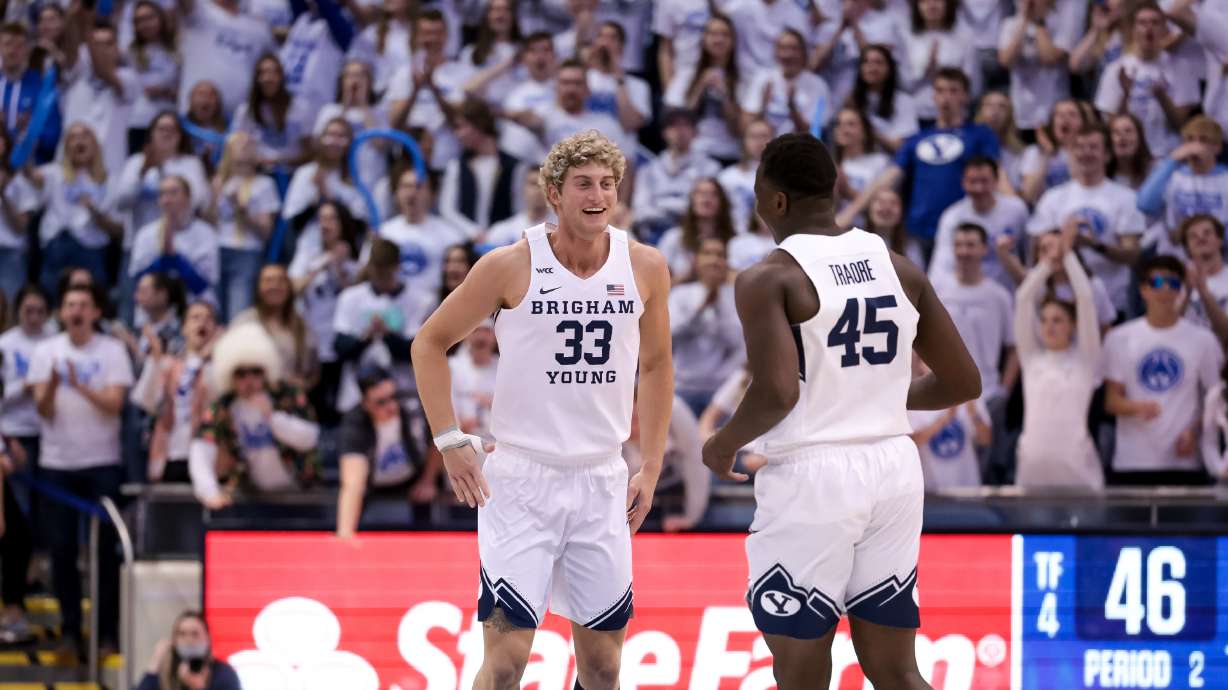 Brigham Young Cougars forward Caleb Lohner (33) and forward Fousseyni Traore (45) celebrate after scoring on the Pepperdine Waves during the game at the Marriott Center in Provo on Saturday, Feb. 26, 2022.