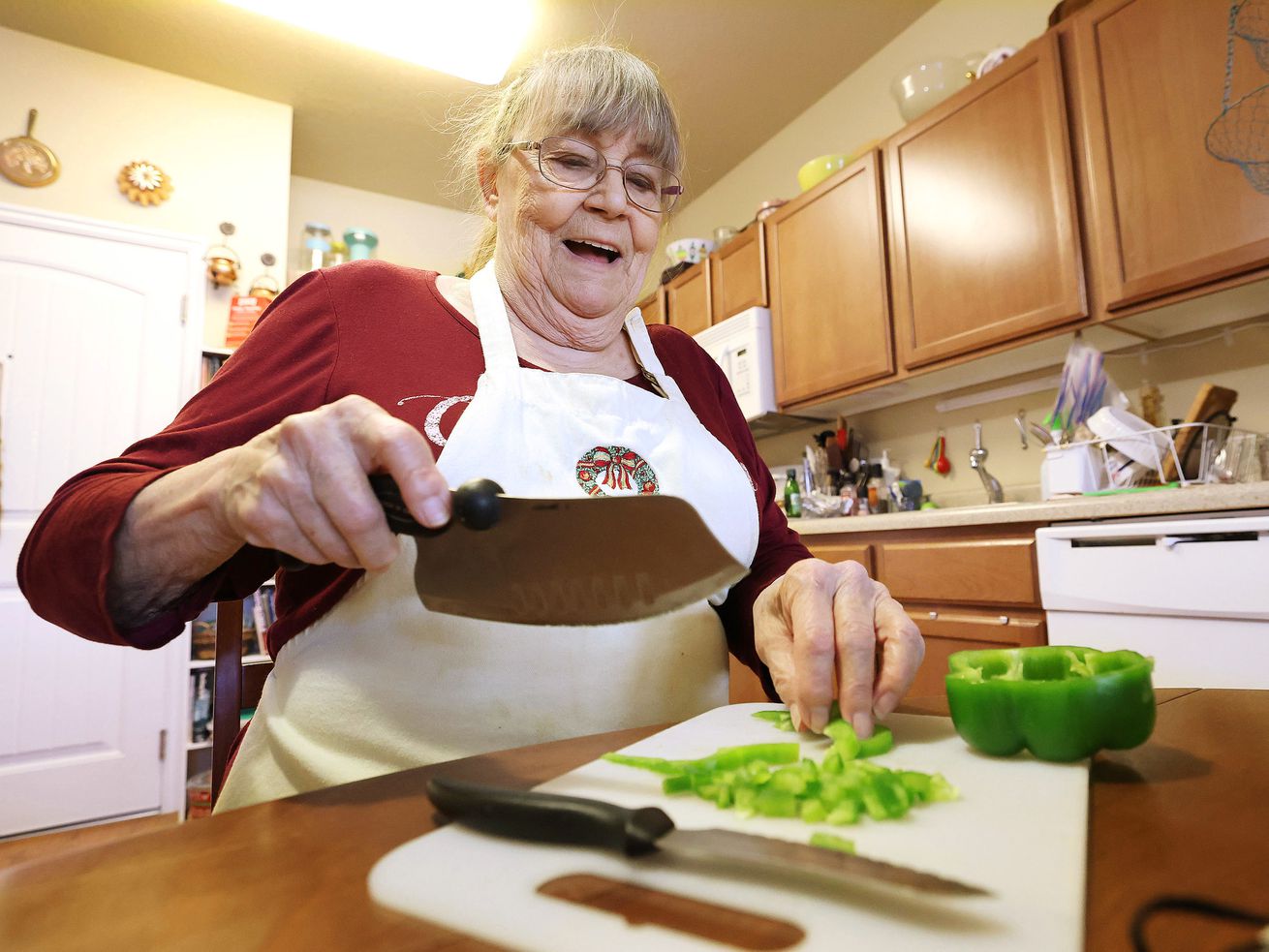 Janice Lamm prepares a meal at her home in West Jordan on Feb. 9. Lamm used Chefpanzee food delivery service during early COVID-19. West Jordan used federal pandemic relief money to create a meals program, which is open to anyone over
the age of 65 residing within the city boundaries.