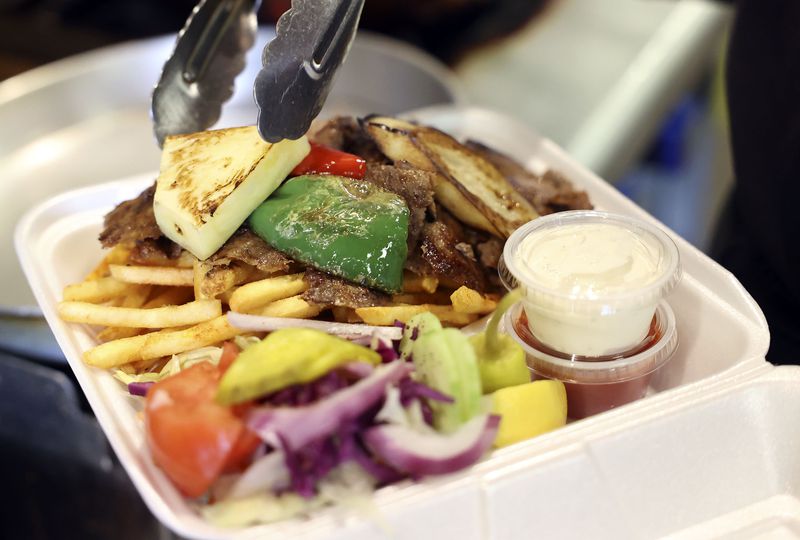 Nailya Ragimova, co-owner and operator of Doner Kebab
Express, prepares a Sofia’s Doner Kebab full-size meal with the
beef lamb option at the restaurant in West Jordan on Thursday.