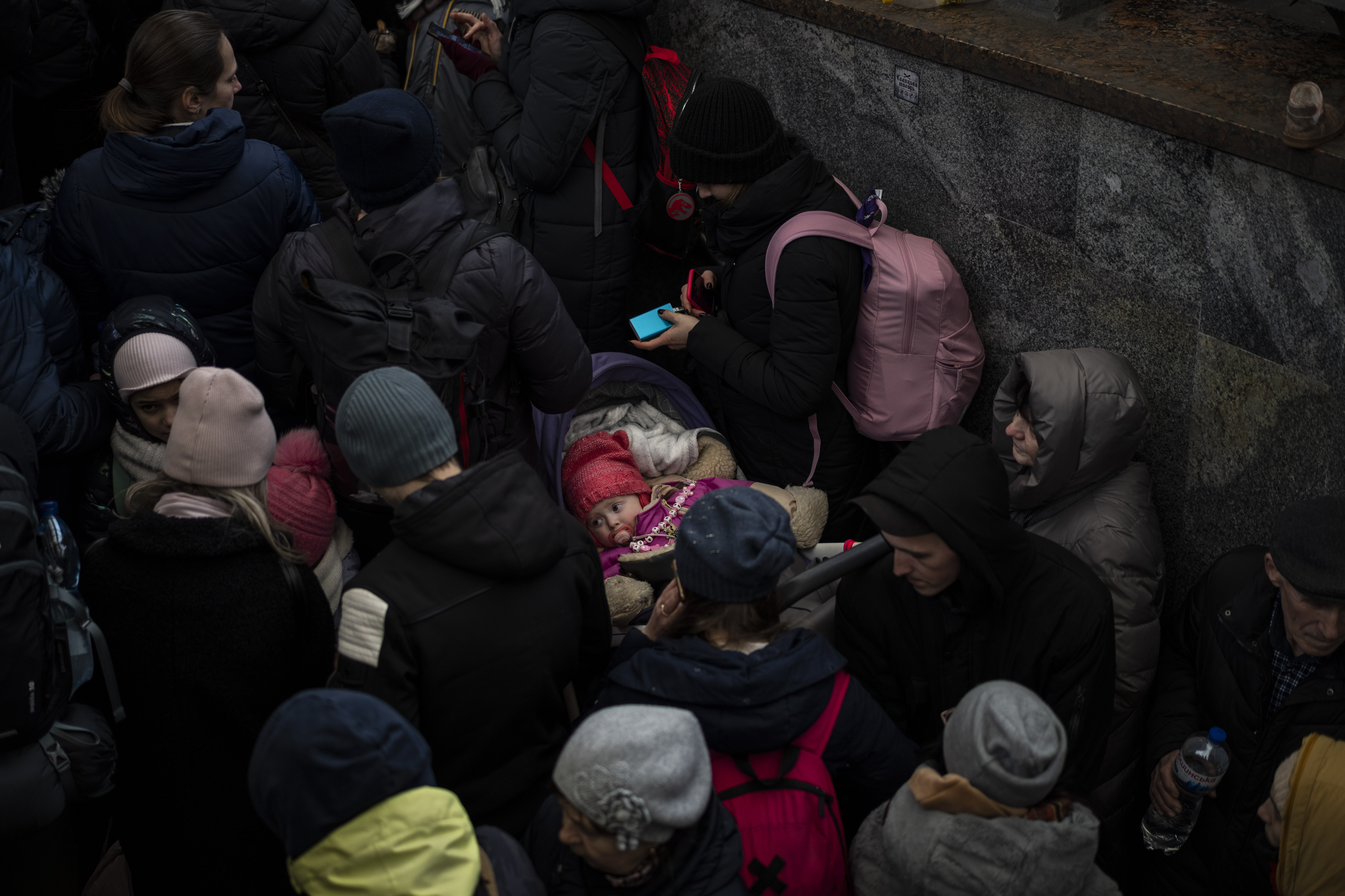Passengers wait for a train to Poland, inside Lviv railway station, Sunday, in Lviv, west Ukraine. The U.N. has estimated the conflict could produce as many as 4 million refugees.