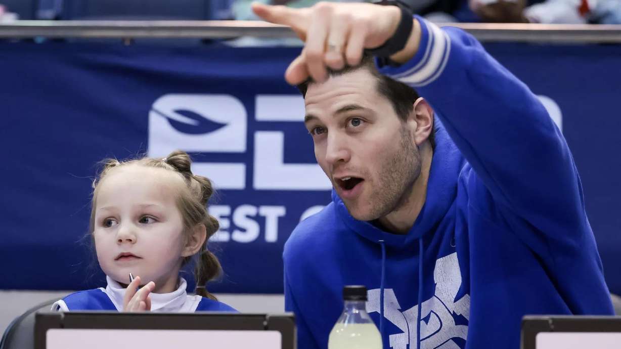 Jimmer Fredette and his 5-year-old daughter Wesley watch the Brigham Young Cougars play the Pepperdine Waves at the Marriott Center in Provo on Saturday.