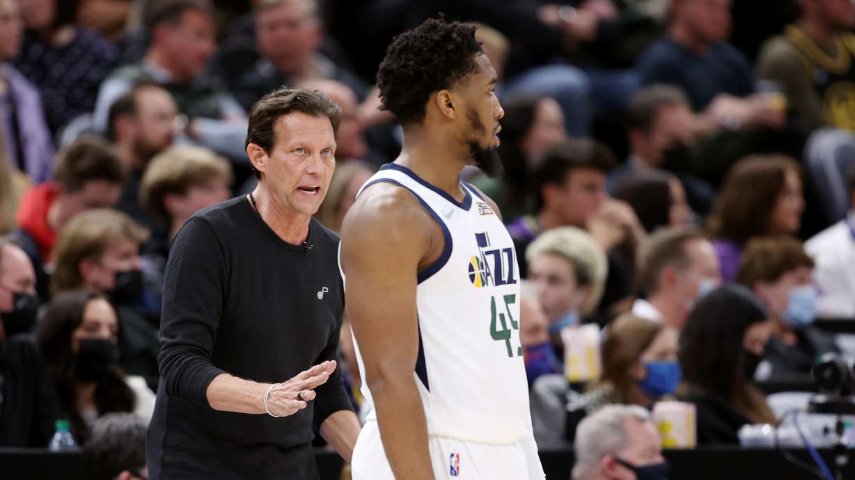 Utah Jazz cead coach Quin Snyder, talks to guard Donovan Mitchell (45) during an NBA basketball game.