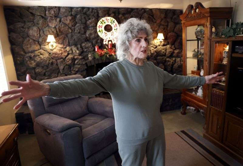 Cheryl Johnson talks about her home, which she has
lived in for nearly 60 years, in South Salt Lake on Thursday. Her late husband and father-in-law, who were both masonry
workers, built the wall around the fireplace behind her out of lava
rock. Johnson is grateful for the Circuit Breaker property tax
relief program, which helps her stay in her home as property taxes
rise.