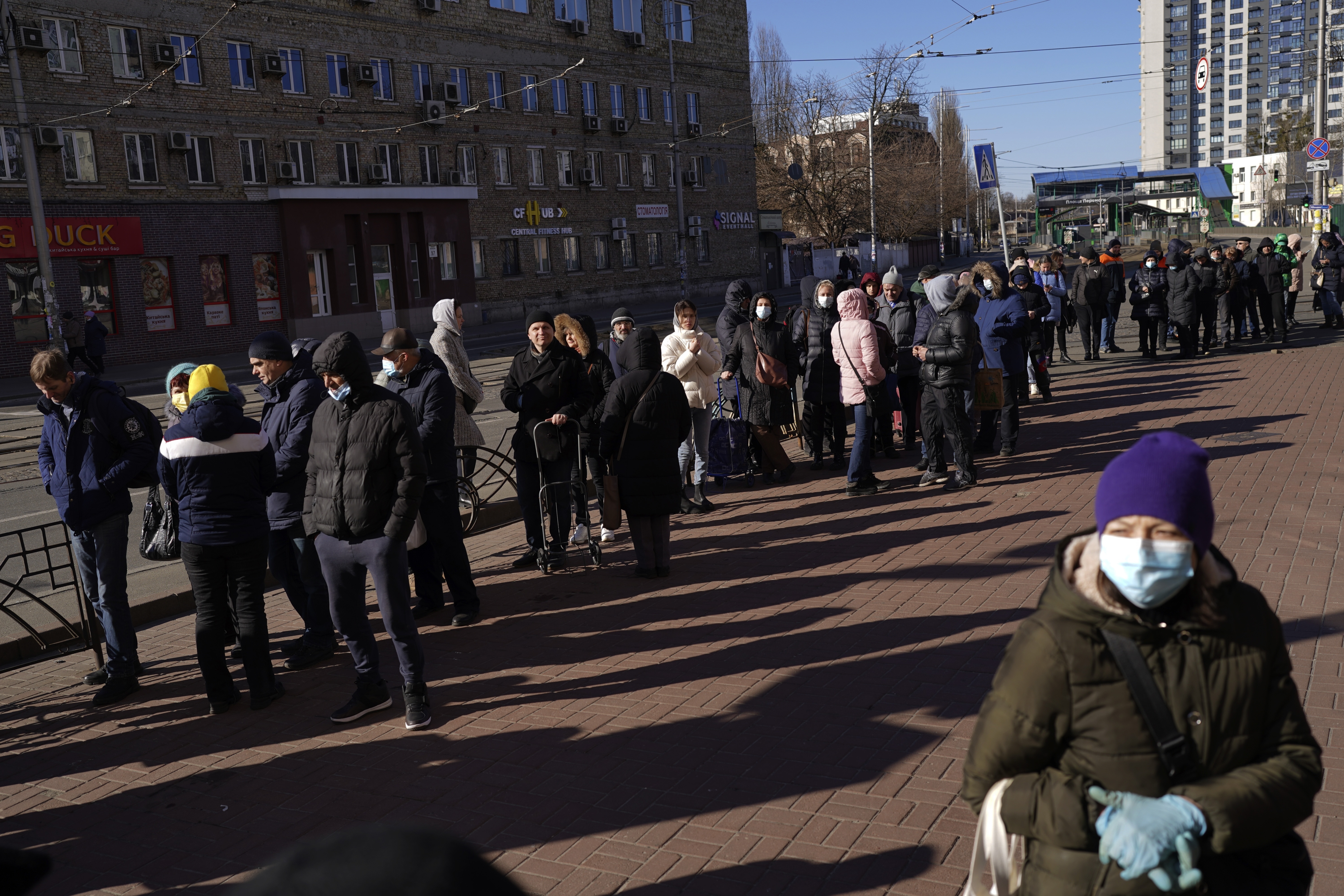 People wait in a queue outside a supermarket in central Kyiv, Ukraine, Monday.