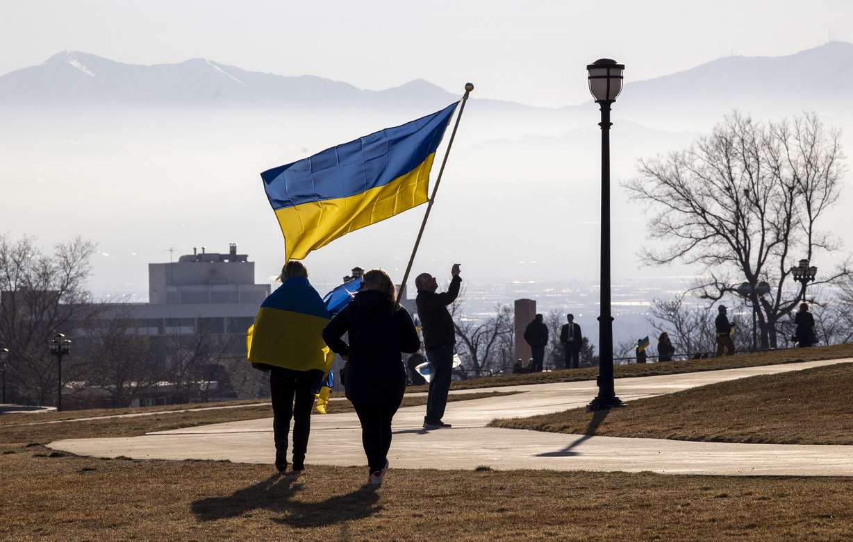 Two women carrying a Ukrainian flag walk to the south steps of the Capitol in Salt Lake City to take part rally to support the Eastern European country on Monday. Gov. Spencer Cox ordered the Ukrainian flag be flown over the state Capitol on Monday.