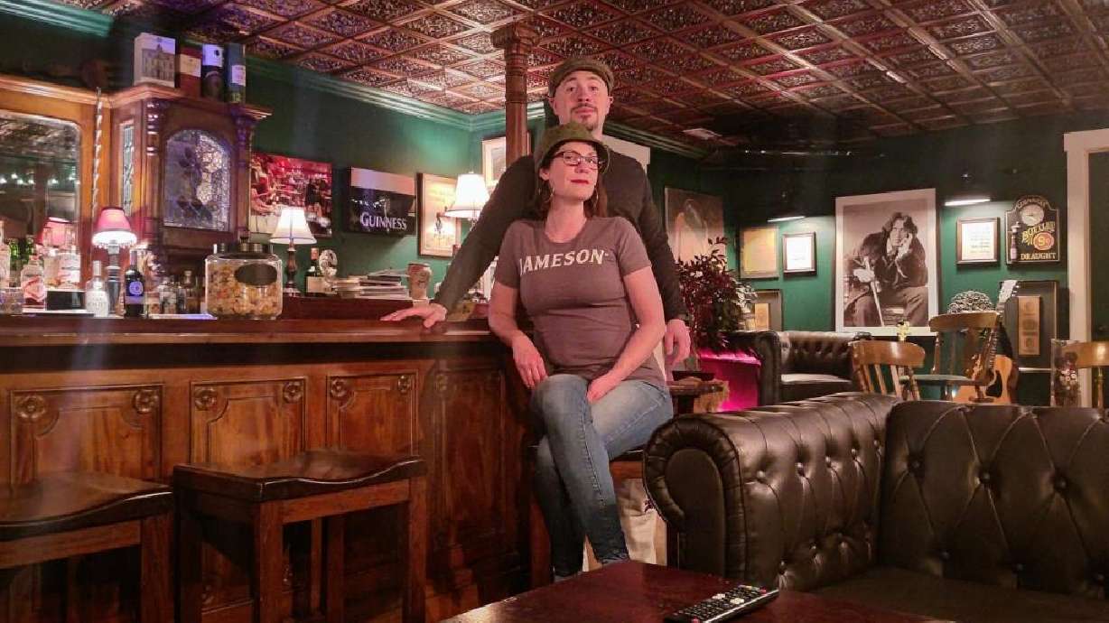 Brian Govatos and Allison Tiné pose for a picture in their basement in Spanish Fork where they built an Irish pub in their basement.