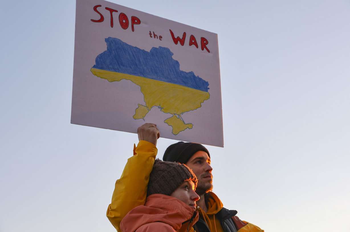 Alexandra V. and Dima P. hold a sign during a prayer to support Ukraine at the Capitol in Salt Lake City on Monday.