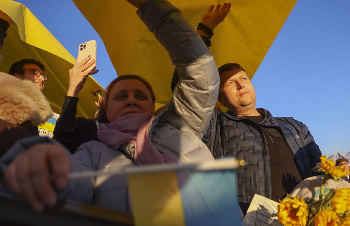 Sophia Baikoush, left, holds a flag of Ukraine at the Capitol in Salt Lake City on Monday.