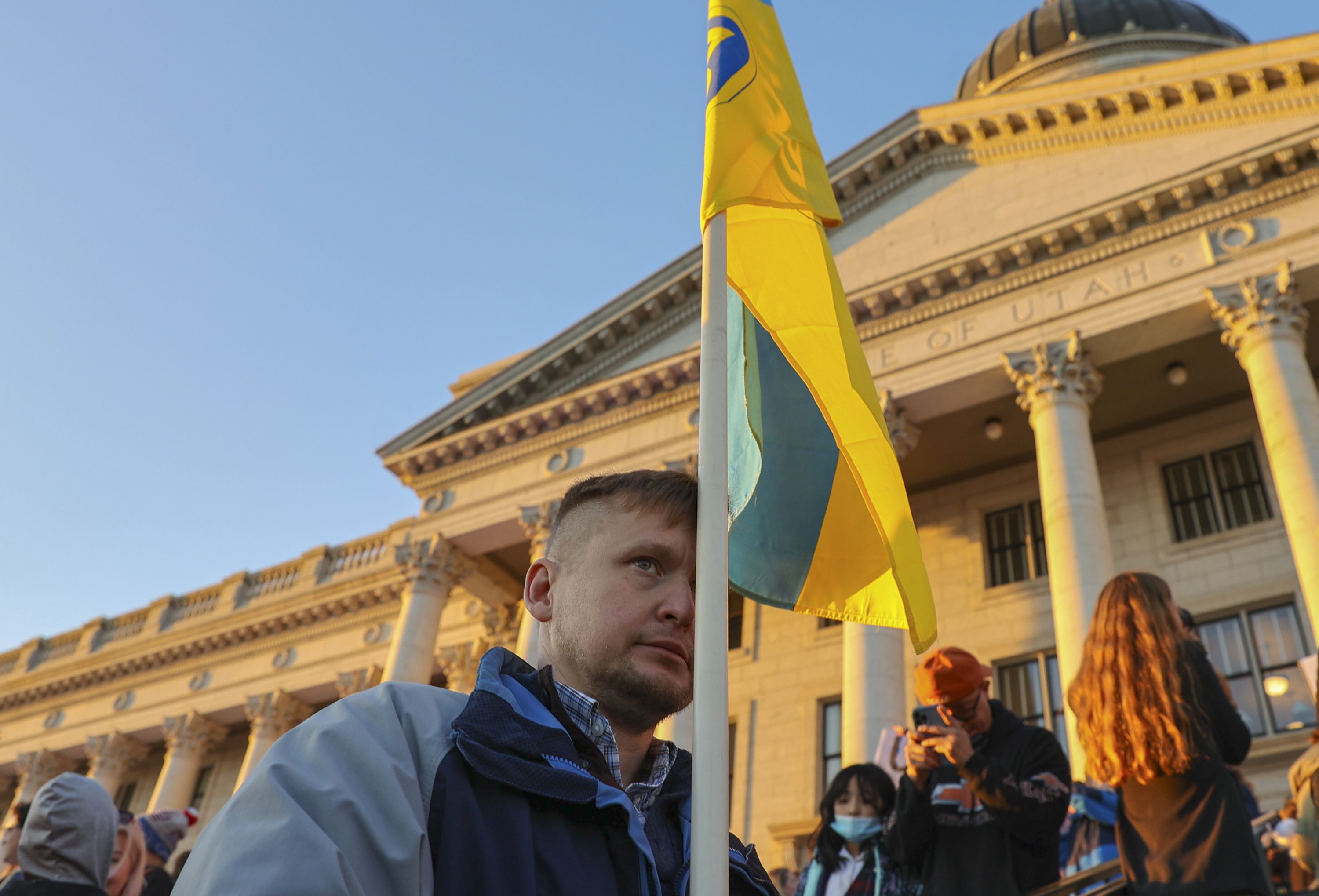 A man holds a Ukraine flag in front of the Capitol in Salt Lake City on Monday. After Russia invaded Ukraine in February, Soloman Smith decided he wanted to help — but he went a lot farther than many people would.