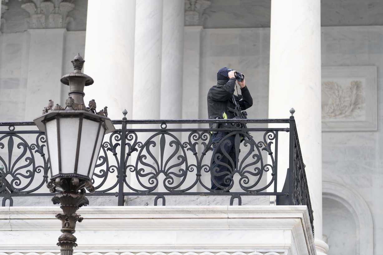 A U.S. Capitol Police officer checks outside of the Capitol building, Tuesday, March 1, 2022, in Washington. President Joe Biden will deliver his first State of the Union address at a precipitous moment for the nation. Biden is aiming to navigate the country out of a pandemic, reboot his stalled domestic agenda and confront Russia’s aggression.