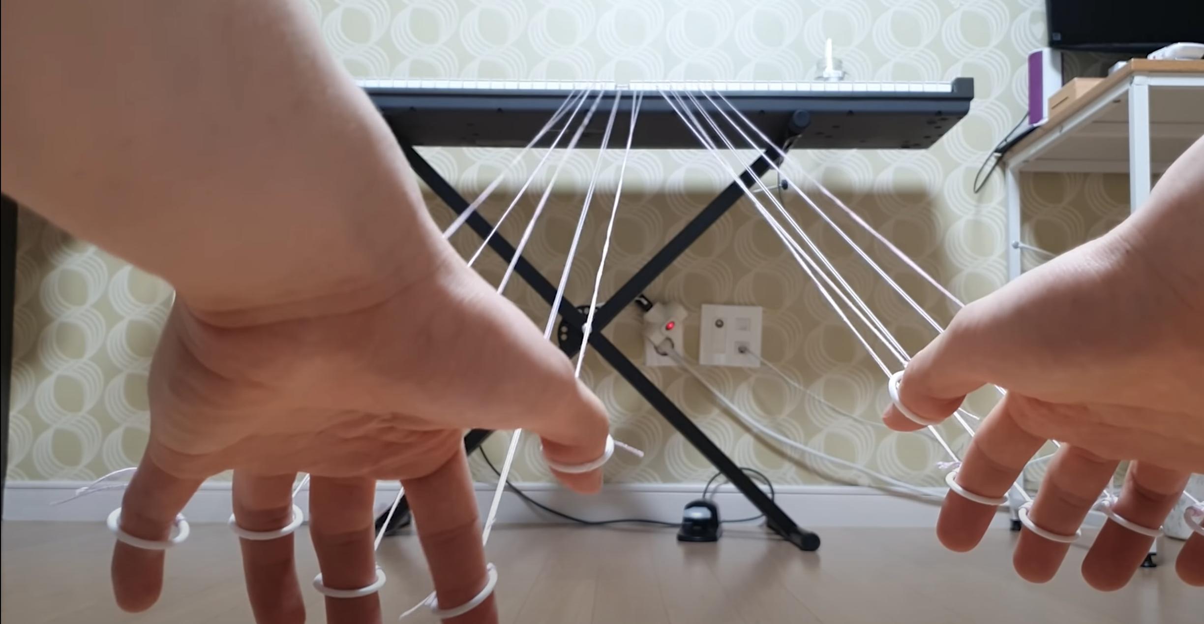 A South Korean pianist plays a keyboard via social distancing with strings.