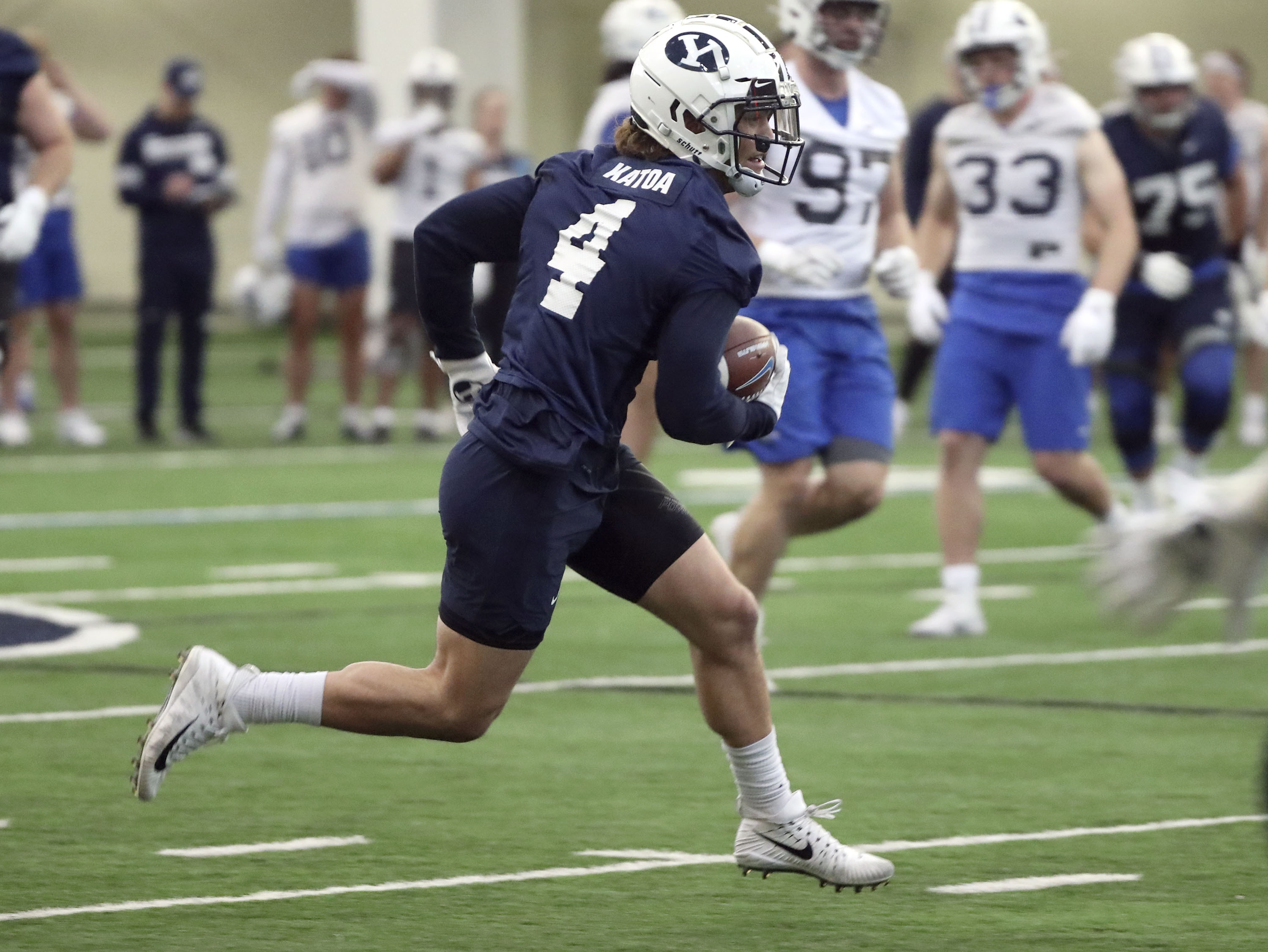 BYU running back Lopini Katoa runs with the ball during practice in the Indoor Practice Facility at BYU in Provo on Monday, Feb. 28, 2022.