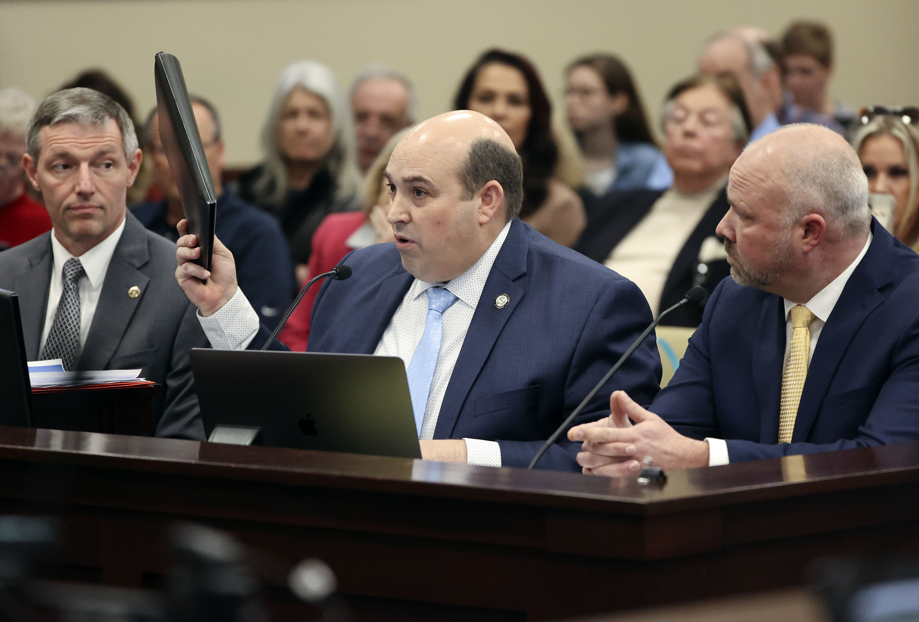Rep. Walt Brooks, R-St. George, holds up what he says is a list of 4,000 CEOs and owner-operators who support HB60S02 vaccine passport amendments during a Senate Revenue and Taxation Standing Committee meeting in the Senate building in Salt Lake City on Tuesday.