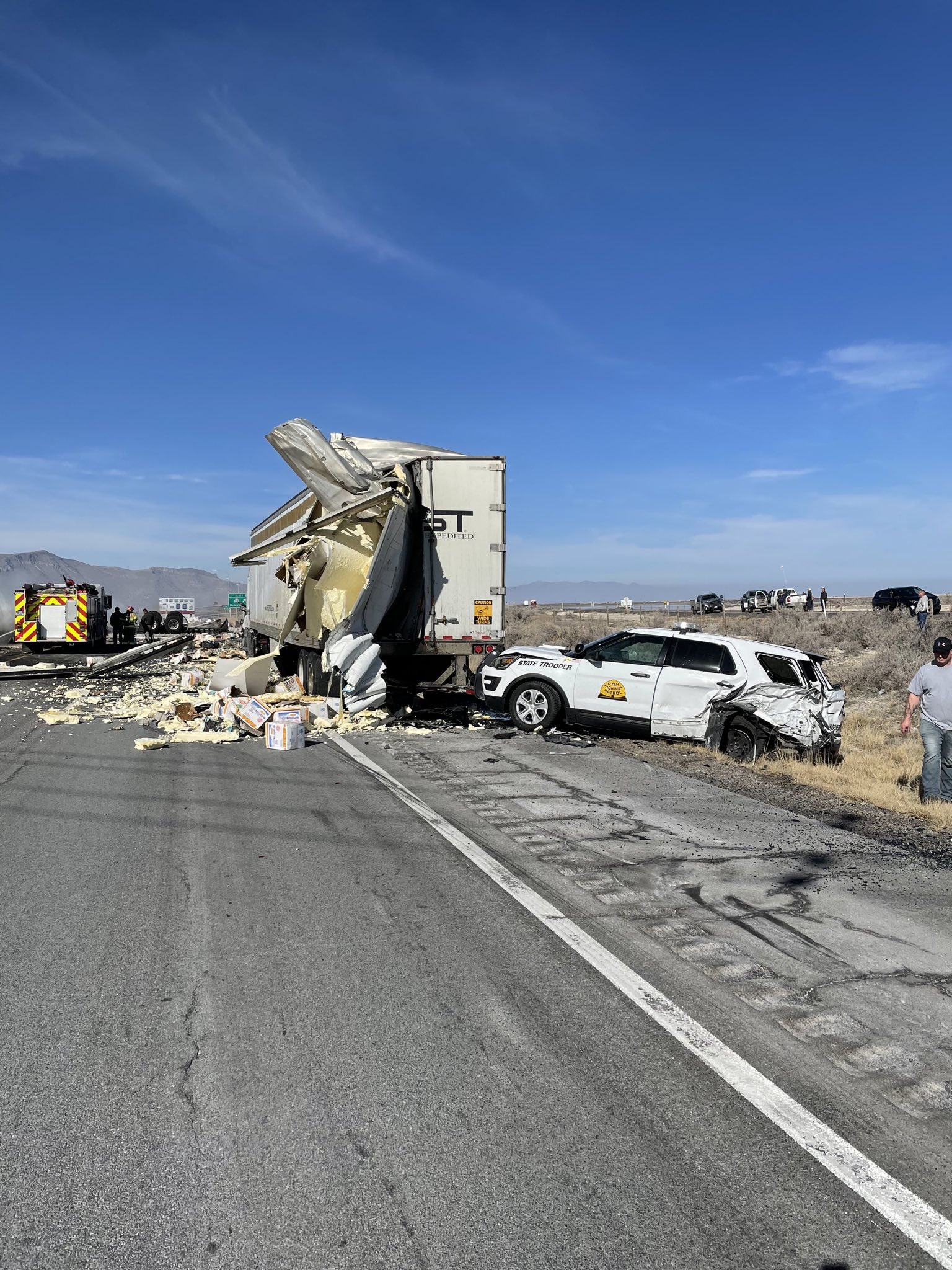 A semi sideswiped a Utah Highway Patrol vehicle and another semi on I-80 in Tooele County on Wednesday before rolling and catching fire. All westbound lanes near Grantsville were expected to remain closed for several hours.
