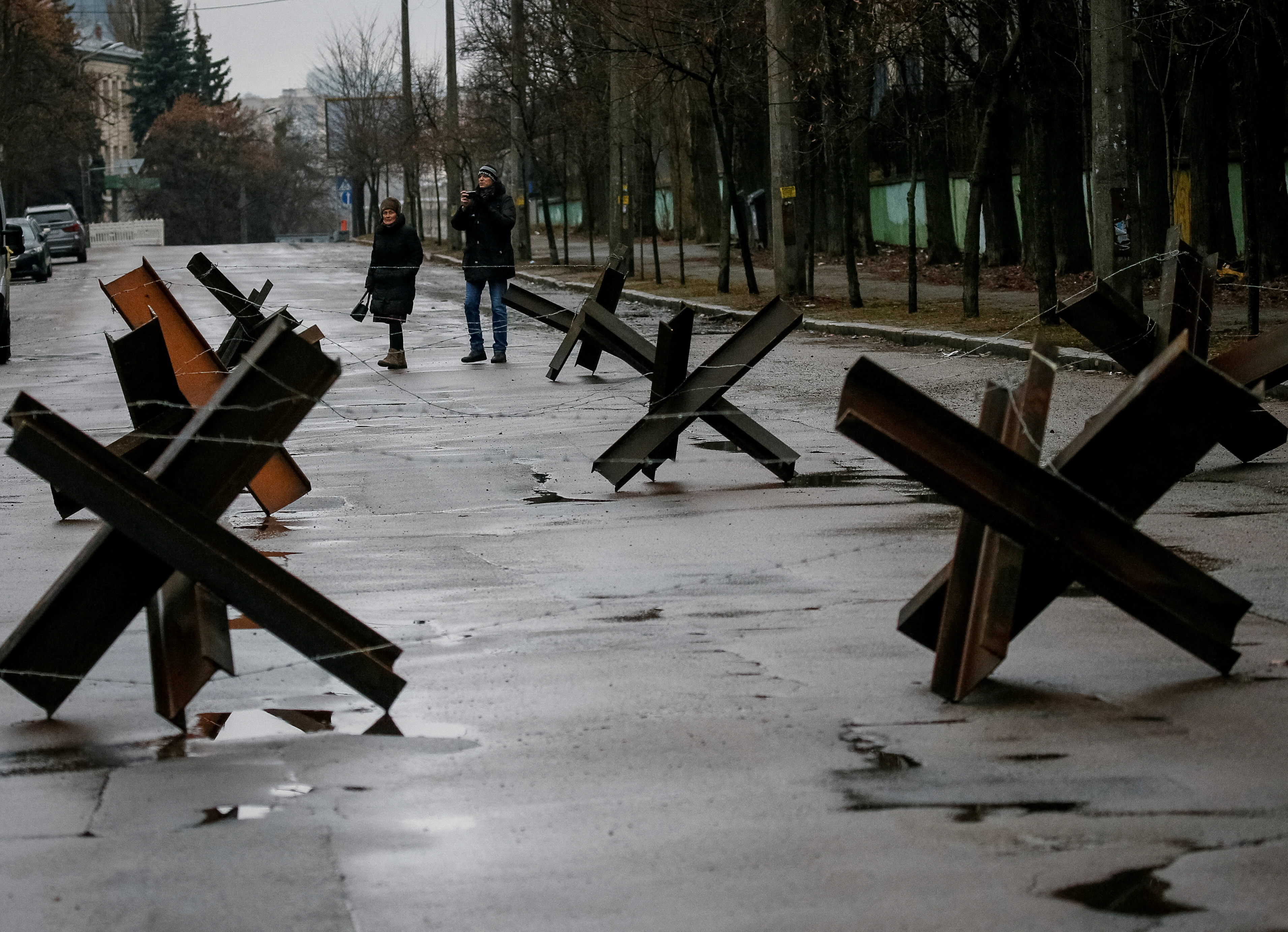 As Russian troops closed in on Ukraine's capital Kyiv on Thursday, a local neighborhood was teeming with workers and welders making anti-tank barricades known as "hedgehogs." 
