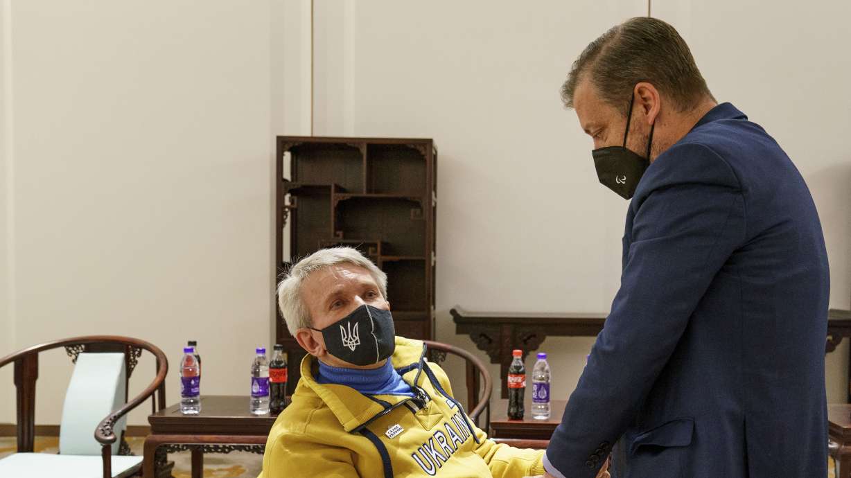 President of the Ukraine National Paralympic Committee Valerii Sushkevych shakes hands with Andrew Parsons, president of the International Paralympic Committee, following the IPC announcement that athletes from the Russian Paralympic Committee and Belarus, despite being called neutral, are no longer allowed to compete at the Beijing 2022 Winter Paralympic Games in Beijing, Thursday.