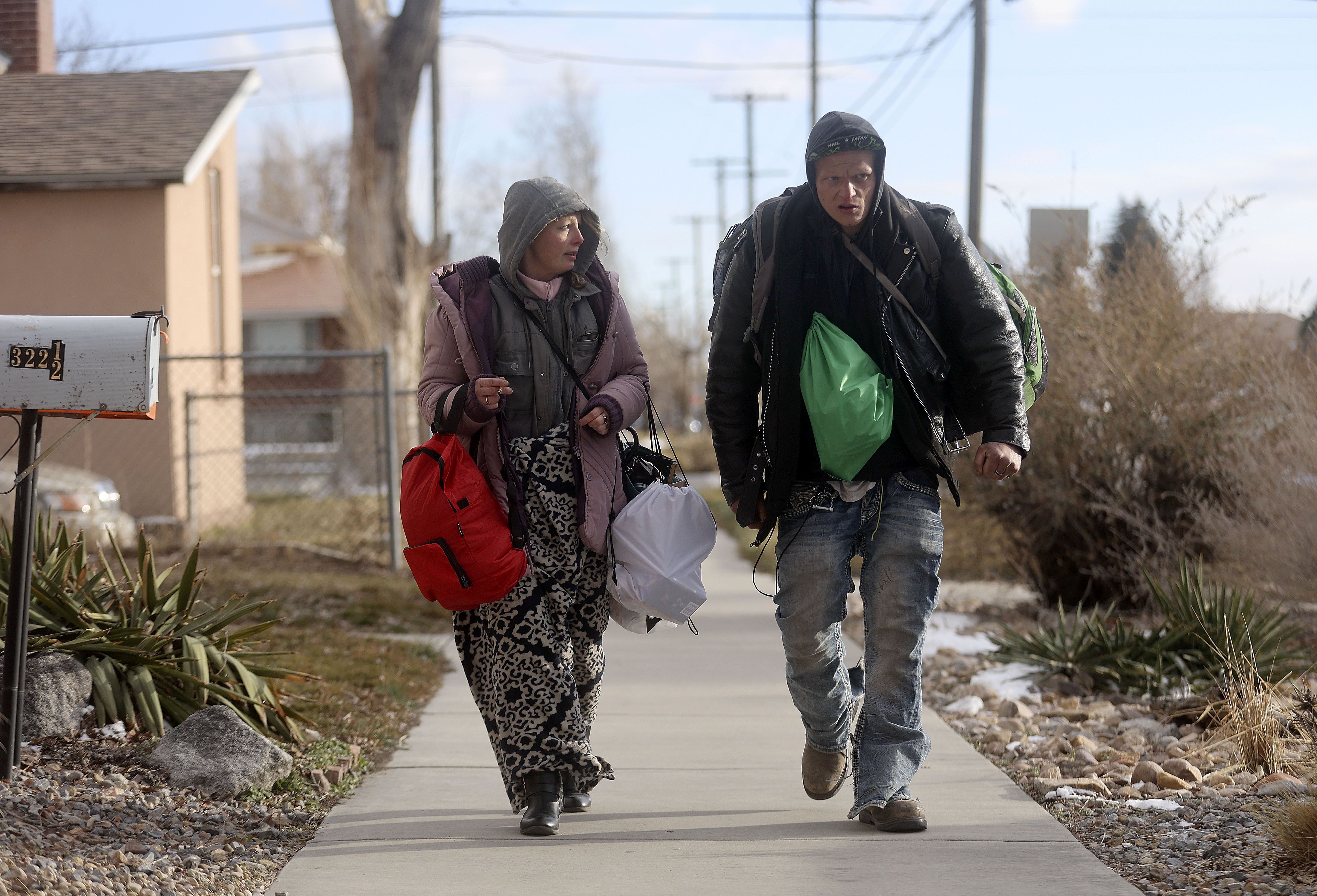 Lacey Kapsimalis and Stoner Sturgis, who have been homeless for five and nine years, respectively, walk through Salt Lake City on Feb. 25. A proposal meant to incentivize cities to provide emergency homeless shelter space in the winter advanced through the Senate on Thursday and is expected to clear a final legislative hurdle on Friday.