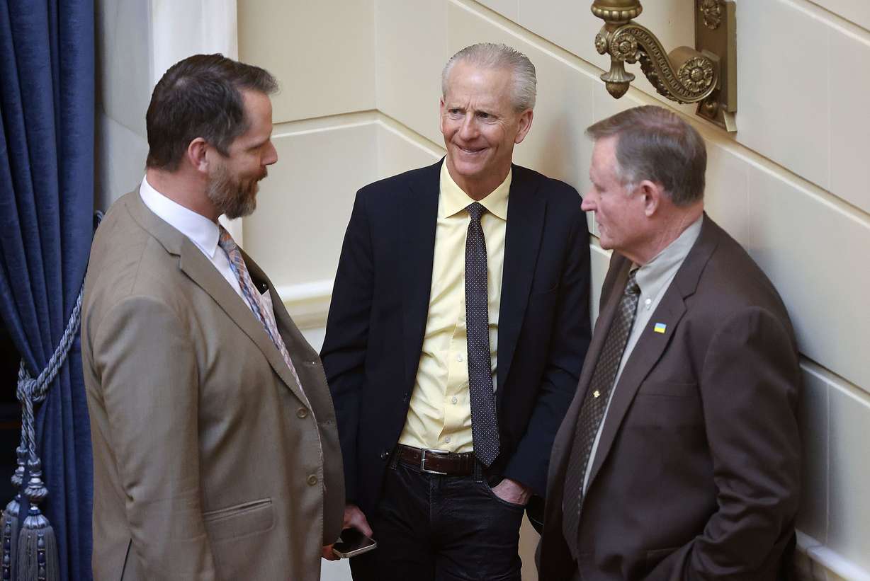 Sen. Jake Anderegg, R-Lehi, left, Wayne Niederhauser, former Utah Senate president and current state homeless services coordinator, and Sen. Evan Vickers, R-Cedar City, talk in the Senate chamber at the Capitol in Salt Lake City on Wednesday.