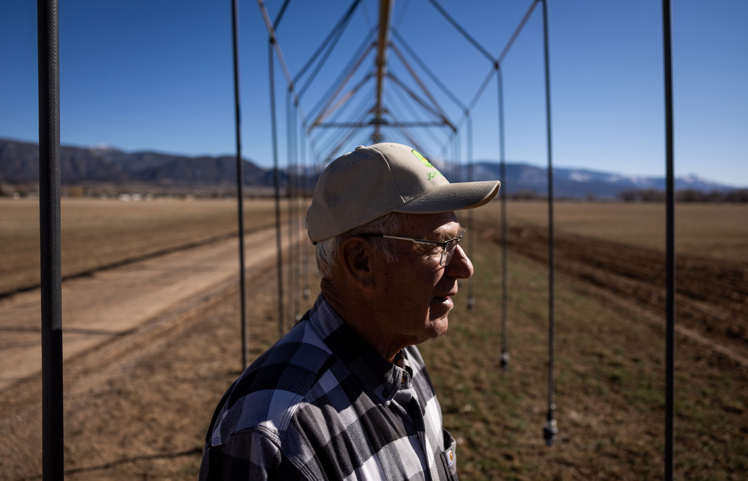 Brent Hunter poses for a photo under a pivot irrigator on his farm in Cedar City on Feb. 18. Rural areas of Utah are facing a dire water shortage and it is setting the blueprint for a western desert conflict.