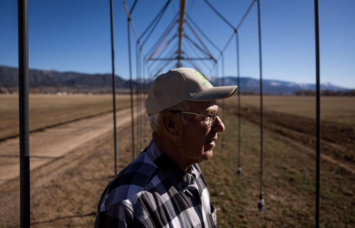 Brent Hunter poses for a photo under a pivot irrigator on his farm in Cedar City on Feb. 18. Rural areas of Utah are facing a dire water shortage and it is setting the blueprint for a western desert conflict.