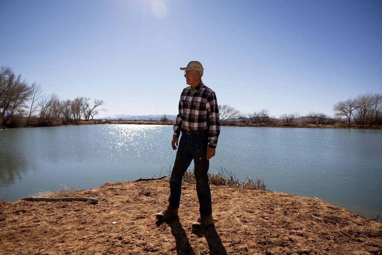 Brent Hunter poses for a photo next to a water storage pond on his farm in Cedar City on Feb. 18. Rural areas of Utah are facing a dire water shortage and it is setting the blueprint for a western desert conflict.