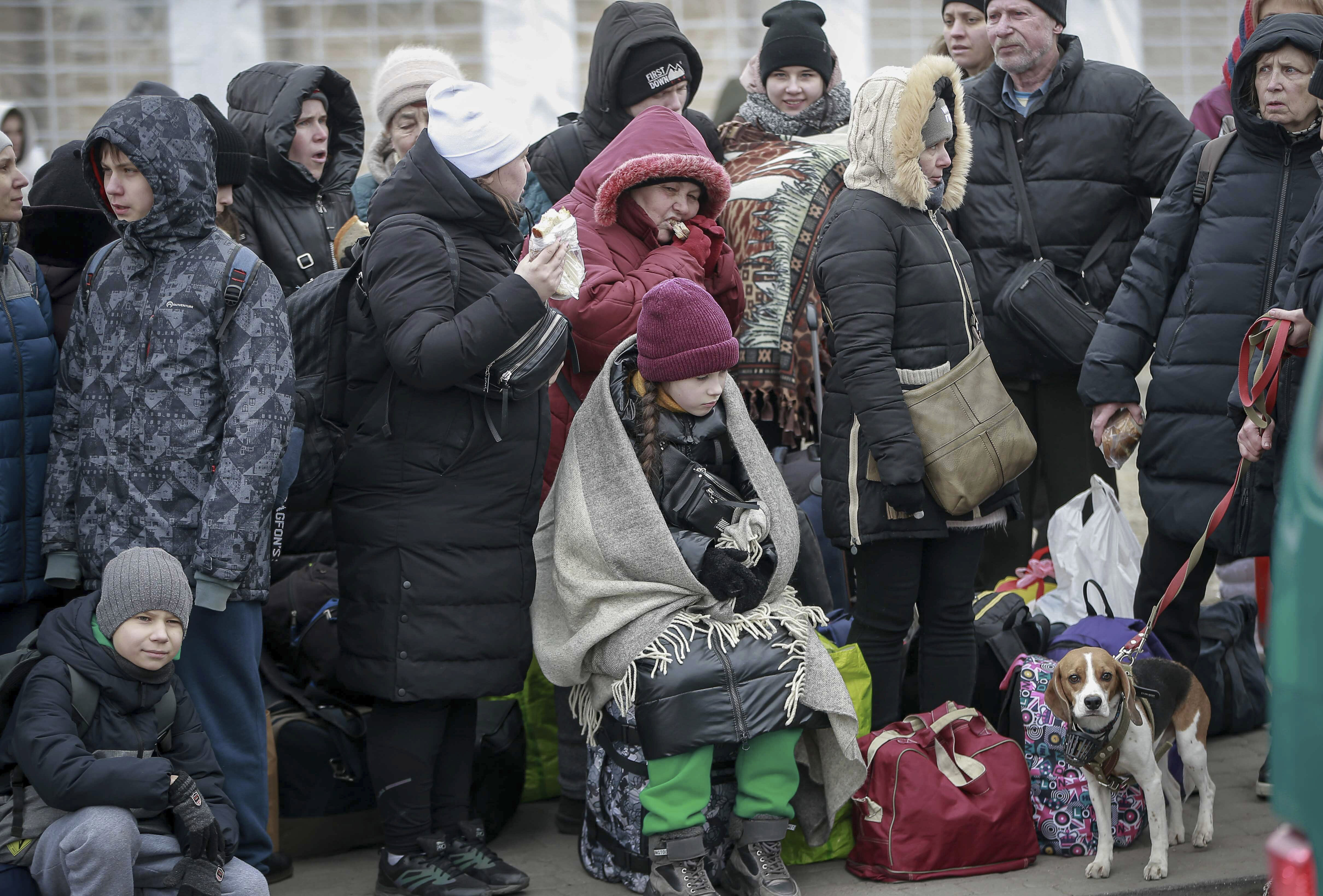 People who left Ukraine, wait for a bus to take them to the train station in Przemysl, at the border crossing in Medyka, Poland, Friday. Hundreds of Utahns, led by Strangeville podcaster and blogger Eli McCann, have put together a two-event fundraiser for Ukrainians in need.
