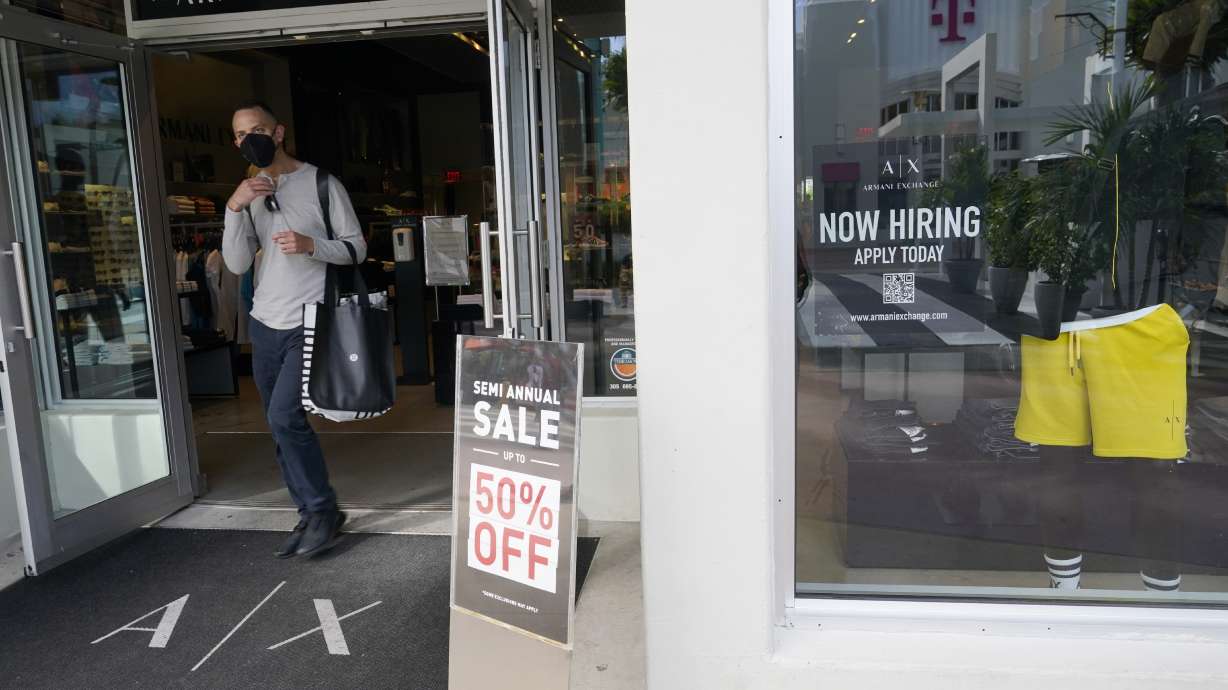 For sale and hiring signs are displayed Jan. 21 in Miami Beach, Fla. U.S. employers added a robust 678,000 jobs in February, the U.S. Department of Labor reported Friday.