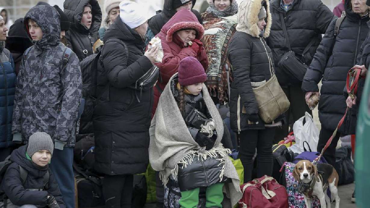People who left Ukraine, wait for a bus to take them to the train station in Przemysl, at the border crossing in Medyka, Poland, Friday. More than 1 million people have fled Ukraine following Russia's invasion in the swiftest refugee exodus in this century, the United Nations said Thursday.
