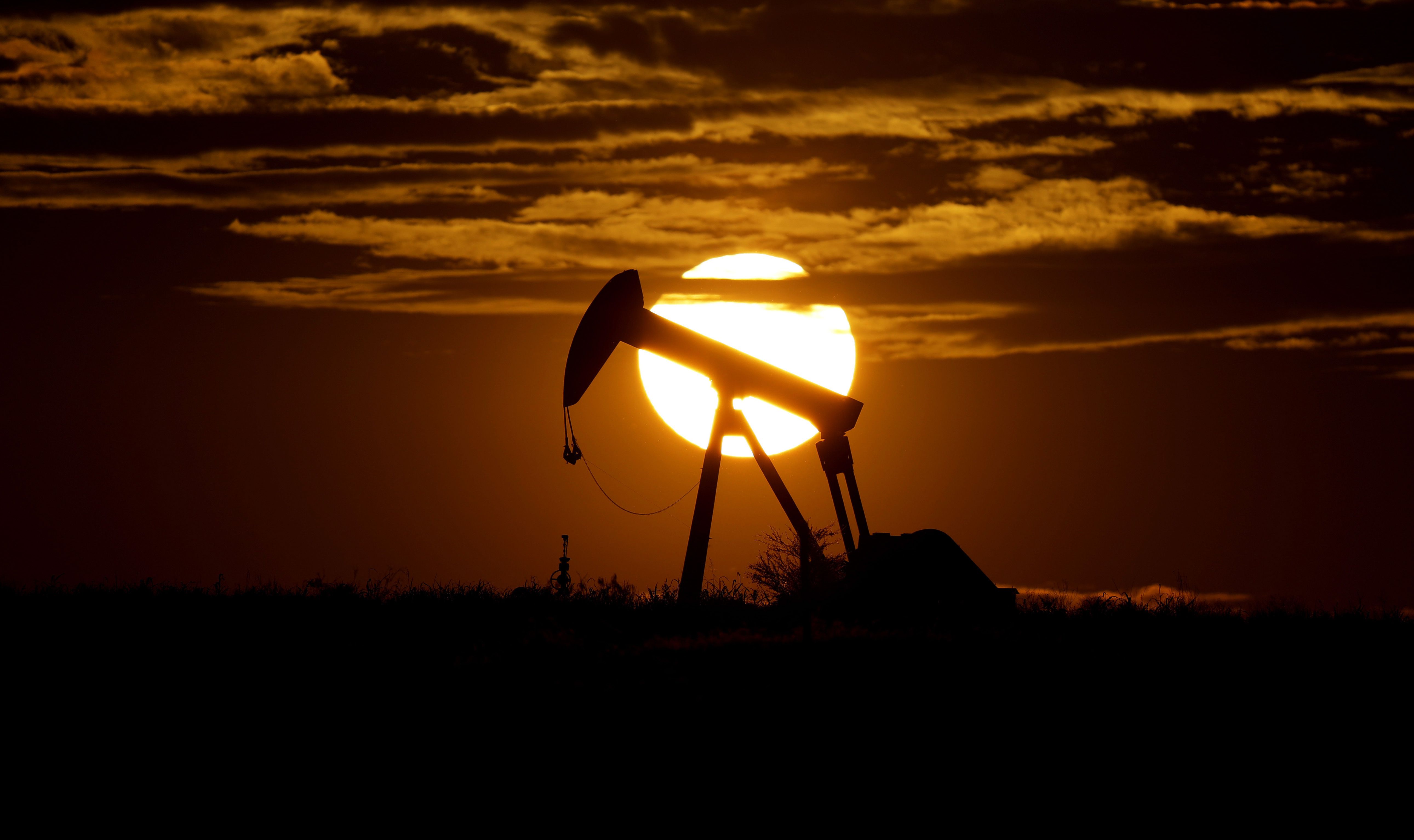The sun sets behind an idle pump jack near Karnes City, Texas, on April 8, 2020. Utah Gov. Spencer Cox joined two dozen other Republican governors across the country calling on President Joe Biden to "restore American energy independence."