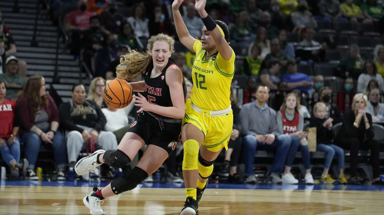 Utah's Gianna Kneepkens (5) drives around Oregon's Te-Hina Paopao (12) during the first half of an NCAA college basketball game in the semifinal round of the Pac-12 women's tournament Friday, March 4, 2022, in Las Vegas.