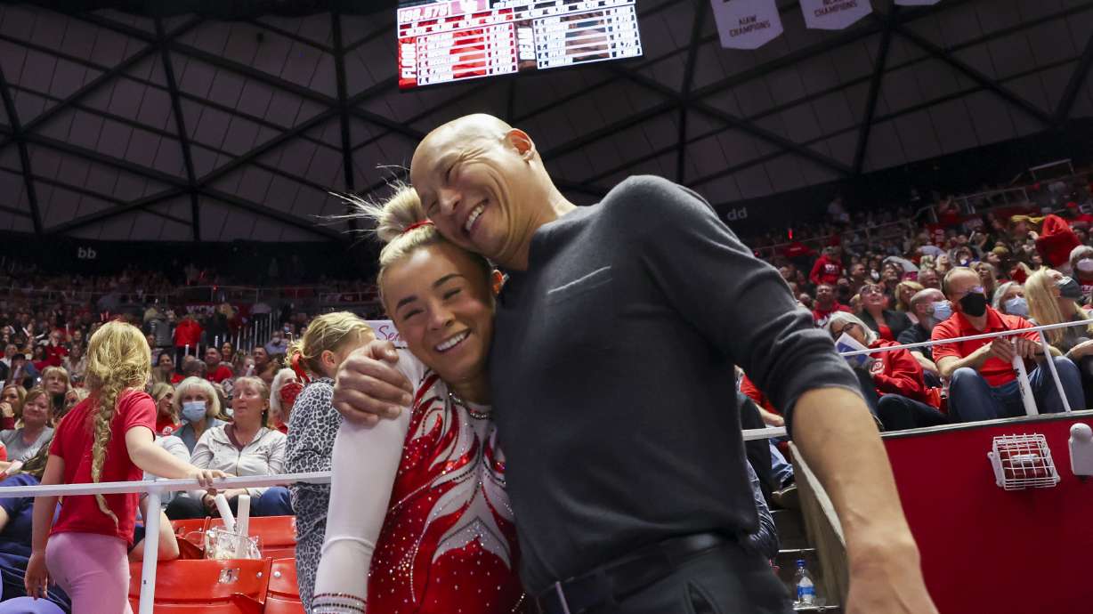 Utah Red Rocks head coach Tom Farden hugs Sydney Soloski after her floor routine as the Utah Red Rocks compete at the Huntsman Center in Salt Lake City on March 4, 2022. A review of the gymnastics coach found he did not engage in "severe, pervasive" abuse, University of Utah officials said Thursday.