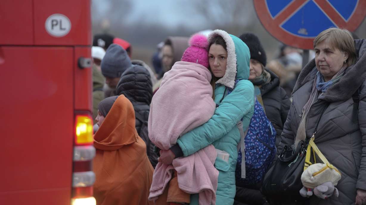 Refugees, mostly women with children, wait for transportation at the border crossing in Medyka, Poland, on Saturday after fleeing from Ukraine.
