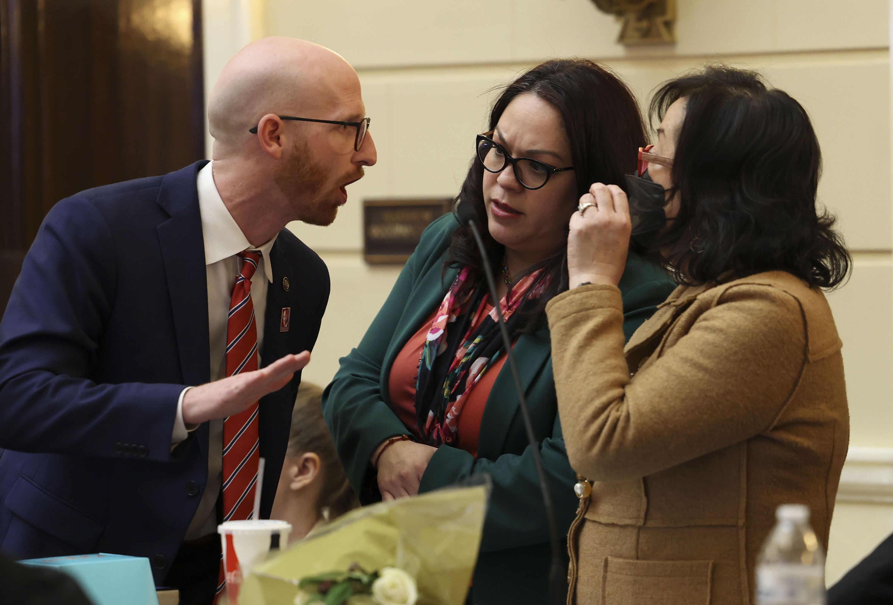 Sen. Derek Kitchen, D-Salt Lake City, Senate Minority Whip Luz Escamilla, D-Salt Lake City, and Sen. Jani Iwamoto, D-Holladay, discuss HB11, Student Eligibility in Interscholastic Activities, during the last evening of the Utah Legislature’s 2022 general session at the Capitol in Salt Lake City on Friday.