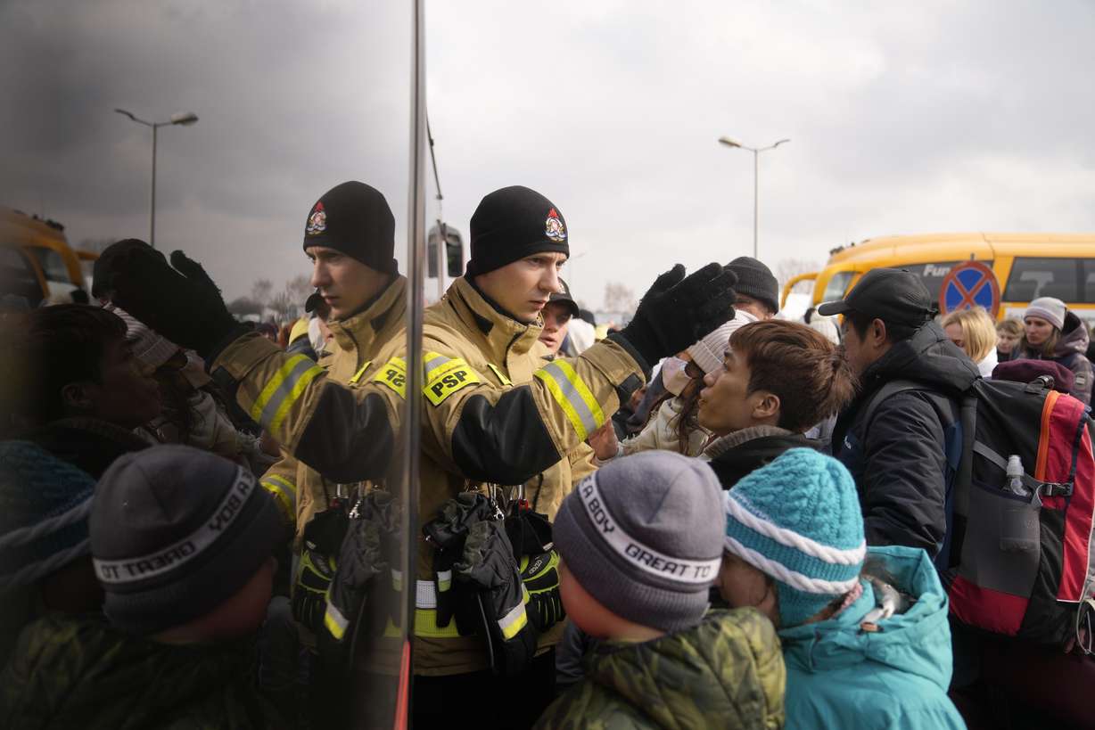 People fleeing from Ukraine queue to board on a bus at the border crossing in Medyka, Poland, on Friday. More than 1 million people have fled Ukraine following Russia's invasion in the swiftest refugee exodus in this century, the United Nations said Thursday.