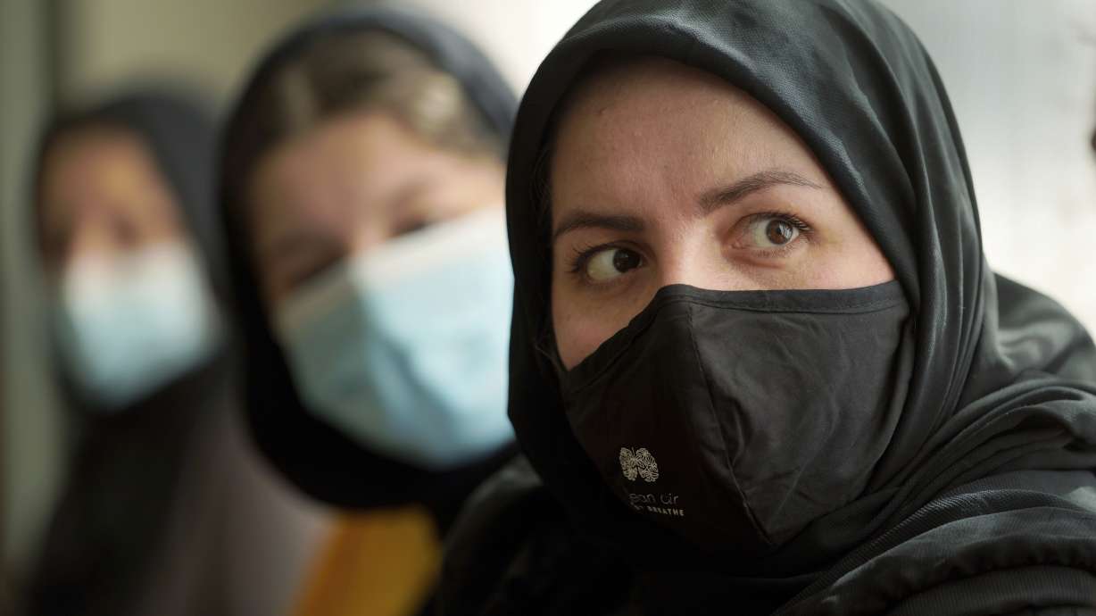 Afghan refugee Mozhgan Entazari, right, talks about the challenge to find proper housing for her family in Southern California, during an interview at a hotel lobby in Irvine, Calif., on Feb. 15. Entazari, 34, said it took four months to find a home.
