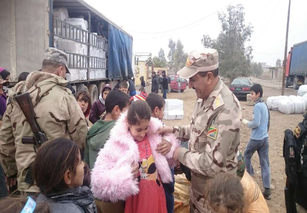 A Yazidi girl chooses a pretty pink coat from a pile of winter clothing provided by Latter-day Saint Charities at a refugee camp in Turkey. Choice is an important principle in helping those receiving aid after a disaster, said the charity’s president, Sister Sharon Eubank.