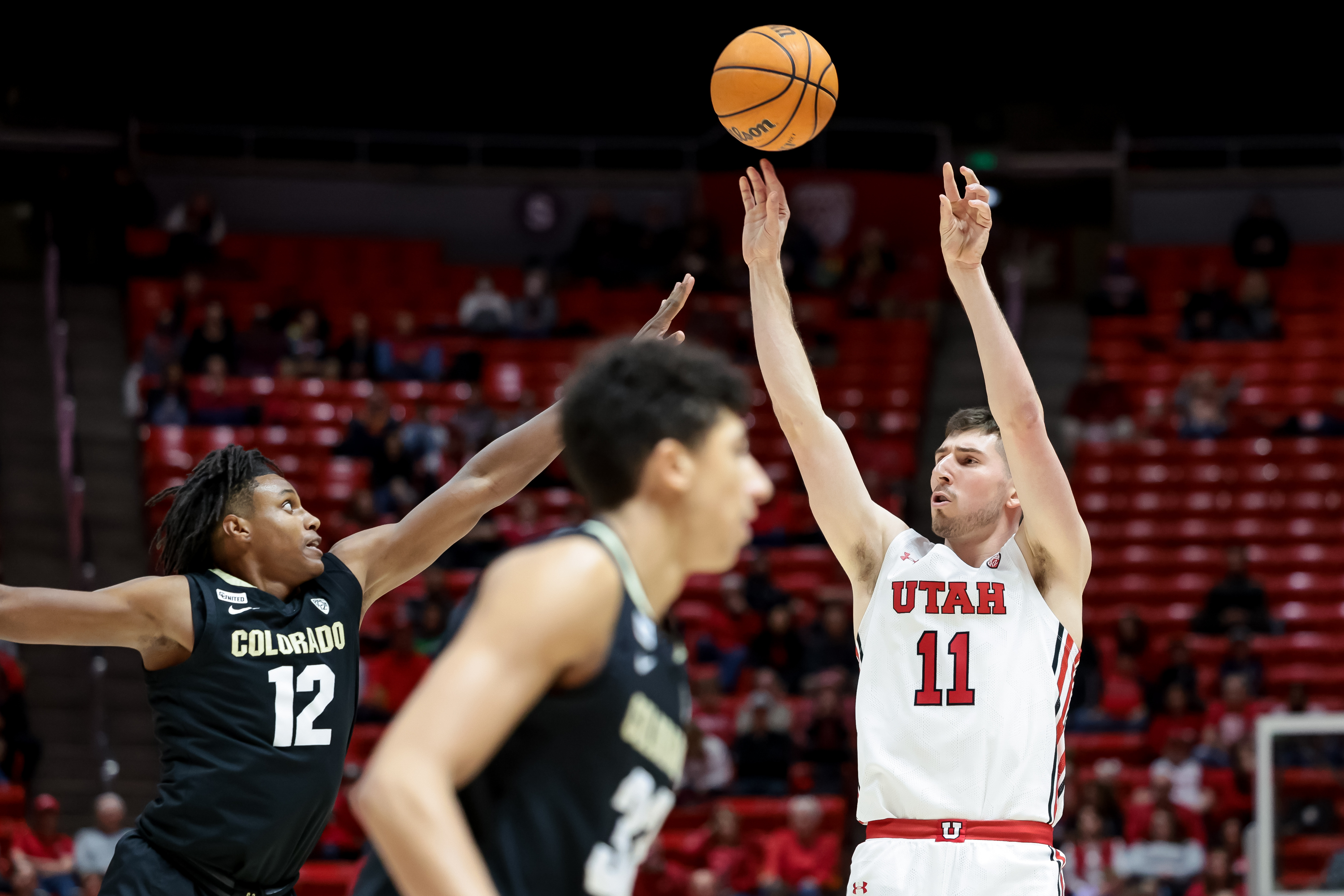 Utah Utes forward Riley Battin (11) shoots over Colorado Buffaloes forward Jabari Walker (12) during the game at the Huntsman Center in Salt Lake City on Saturday, March 5, 2022.
