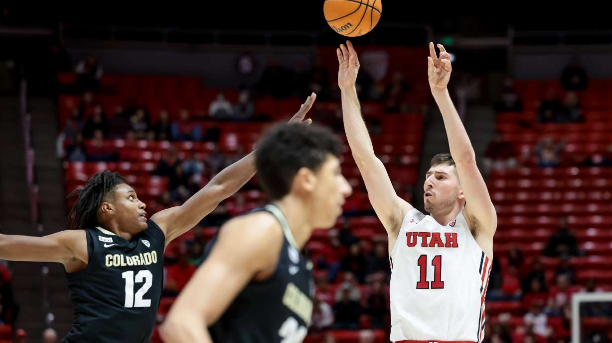 Utah Utes forward Riley Battin (11) shoots over Colorado Buffaloes forward Jabari Walker (12) during the game at the Huntsman Center in Salt Lake City on Saturday, March 5, 2022.