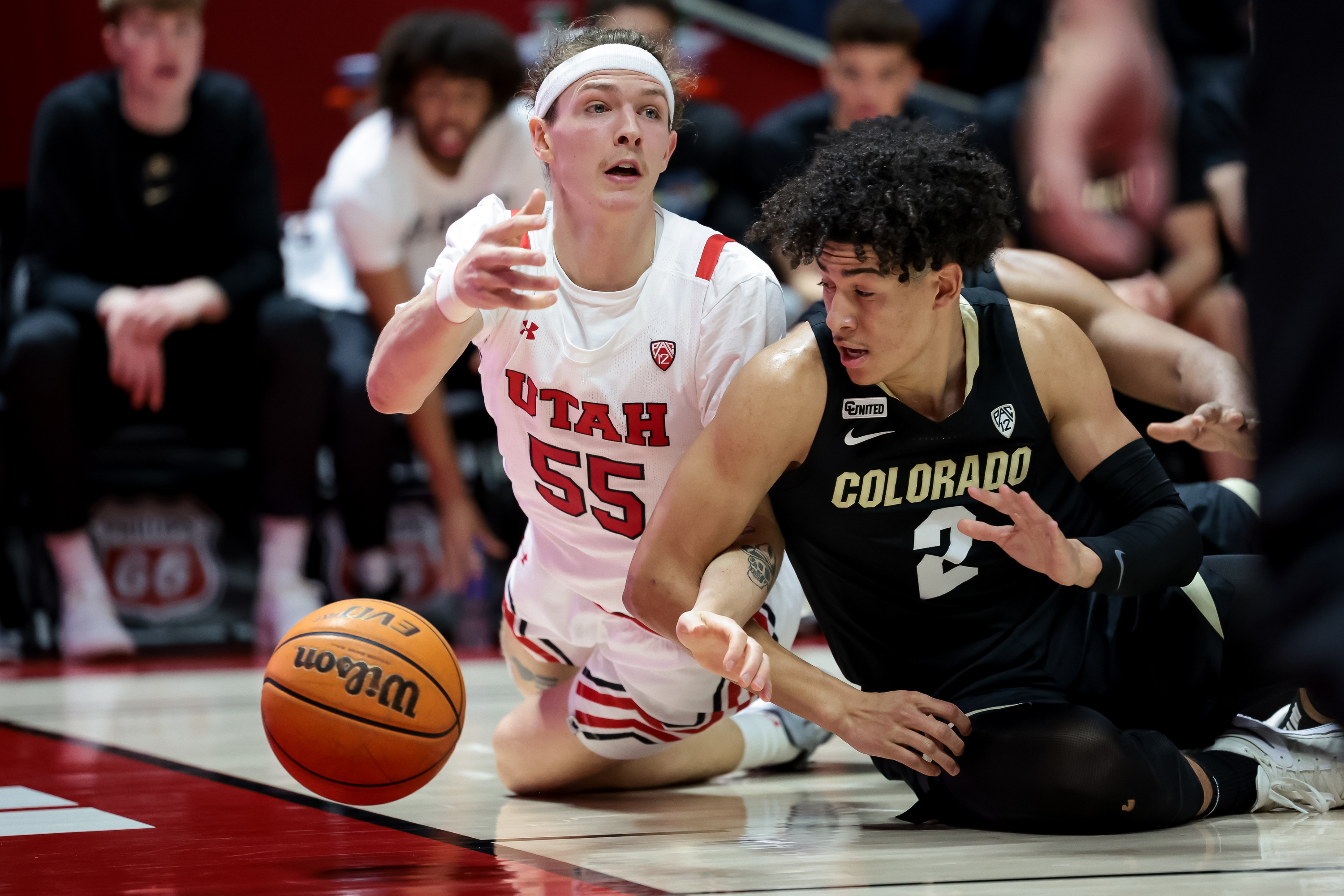 Utah Utes guard Gabe Madsen (55) and Colorado Buffaloes guard KJ Simpson (2) move for a loose ball during the game at the Huntsman Center in Salt Lake City on Saturday, March 5, 2022.