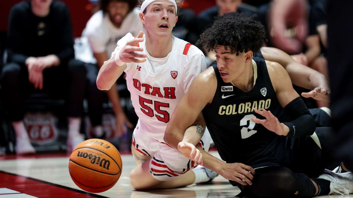 Utah Utes guard Gabe Madsen (55) and Colorado Buffaloes guard KJ Simpson (2) move for a loose ball during the game at the Huntsman Center in Salt Lake City on Saturday, March 5, 2022.