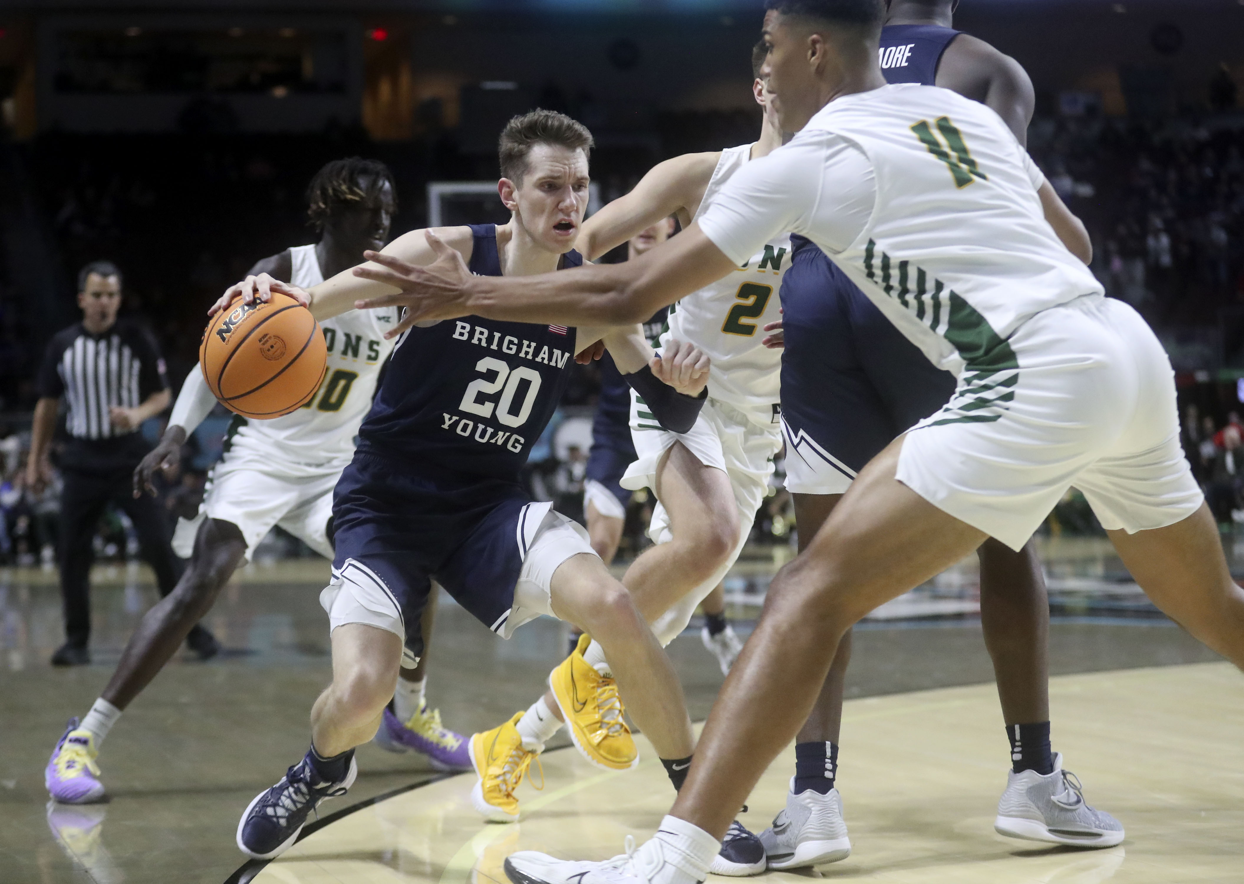 Brigham Young guard Spencer Johnson (20) dribbles as San Francisco forward Patrick Tape (11) guards him in the 2022 West Coast Conference men’s basketball quarterfinals at the Orleans Arena in Las Vegas on Saturday, March 5, 2022. BYU lost 63-75.