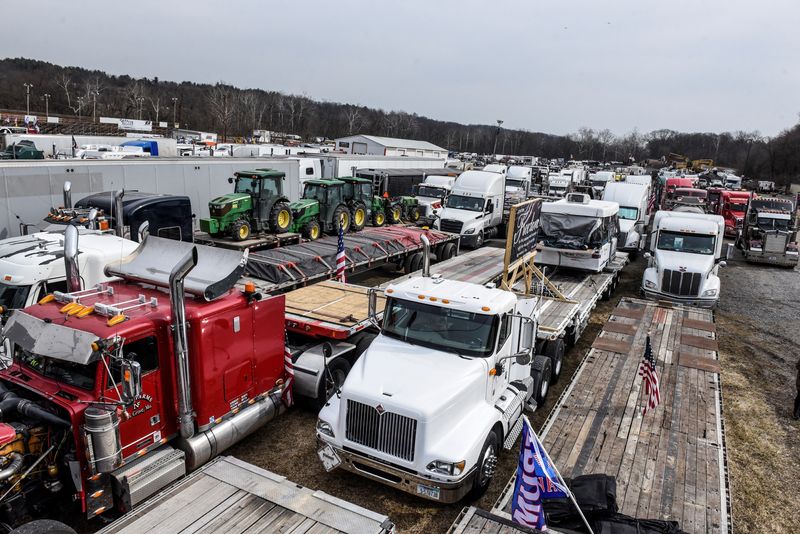 Hundreds of vehicles including 18-wheeler trucks, RVs and other cars are parked as part of a rally at Hagerstown Speedway after some of them arrived as part of a convoy that traveled across the country headed to Washington D.C. to protest coronavirus disease (COVID-19) related mandates and other issues in Hagerstown, Maryland, U.S., March 5, 2022.