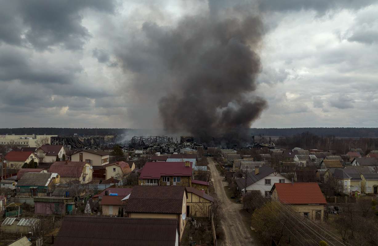 A factory and a store burn after being bombarded in Irpin, on the outskirts of Kyiv, Ukraine, Sunday.