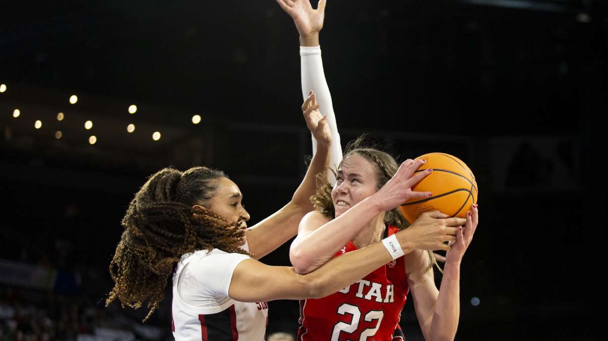 Utah forward Jenna Johnson (22) shoots against Stanford guard Haley Jones (30) during the first half of the NCAA Pac-12 basketball tournament championship game, Sunday, March 6, 2022, in Las Vegas.