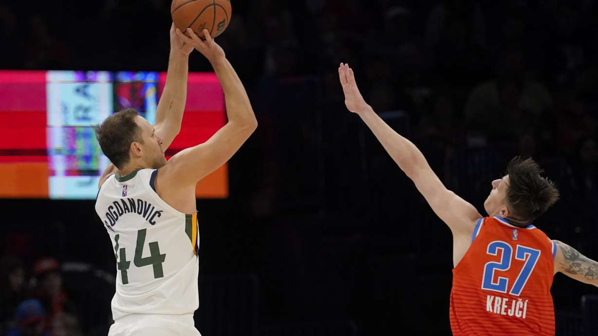 Utah Jazz forward Bojan Bogdanovic (44) shoots over Oklahoma City Thunder guard Vit Krejci (27) in the first half of an NBA basketball game Sunday, March 6, 2022, in Oklahoma City.