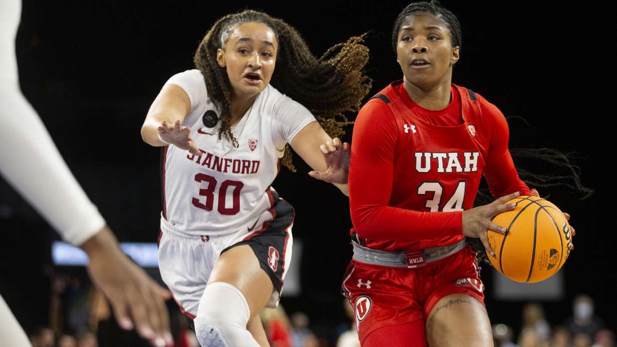 Utah forward Dasia Young (34) dribbles up the court followed by Stanford guard Haley Jones (30) during the first half of the NCAA Pac-12 basketball tournament championship game, Sunday, March 6, 2022, in Las Vegas.