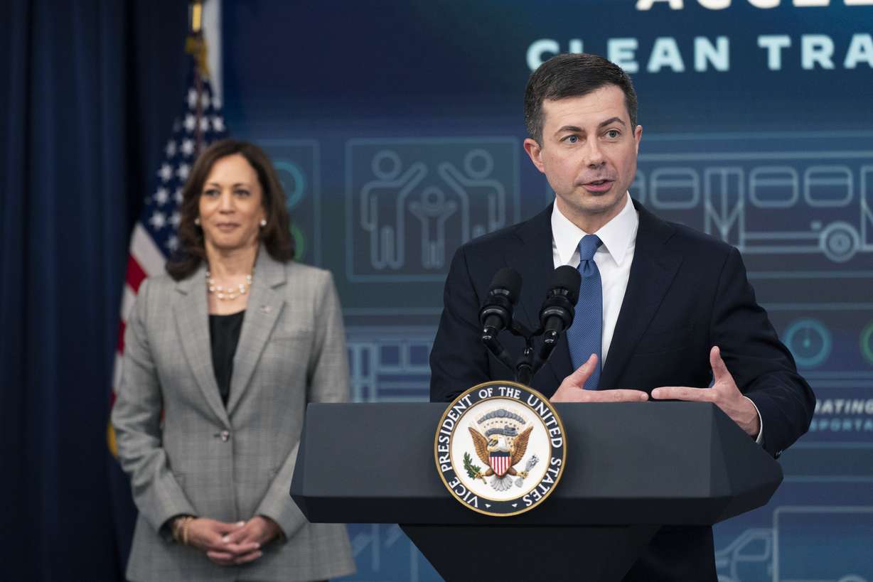 Secretary of Transportation Pete Buttigieg, with Vice President Kamala Harris, speaks, at the Eisenhower Executive Office Building on the White House complex, in Washington, Monday, March 7, 2022.